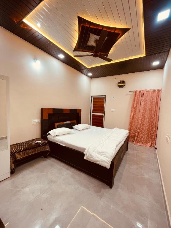 a bedroom with a large bed in a room at Aarambh Homestay in Ujjain