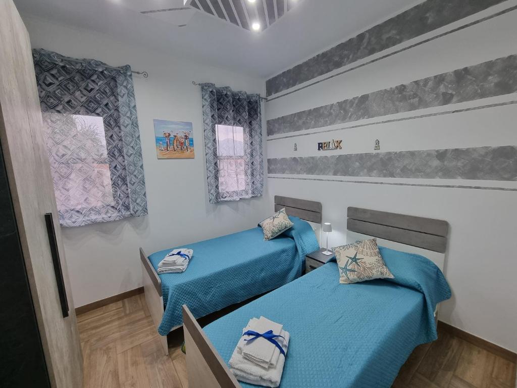 Postel nebo postele na pokoji v ubytování Vida Loca -Appartamento vicino aereporto e 200mt spiaggia