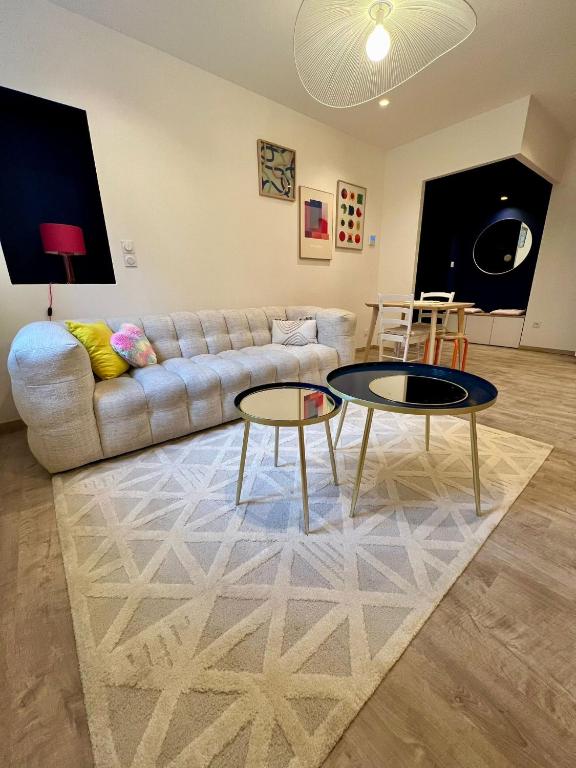 - un salon avec deux tables et un canapé dans l'établissement Appartement Atypique, à Saint-Étienne