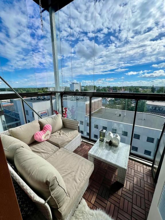 a balcony with a couch and a table on a building at Samu's Castle in Hyvinkää