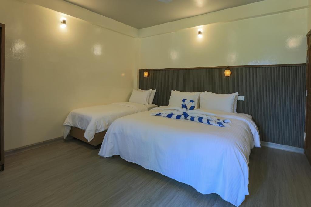 Postel nebo postele na pokoji v ubytování Dhoadhi Beach Maldives