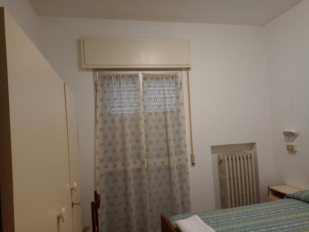 Postel nebo postele na pokoji v ubytování Hotel Toschi