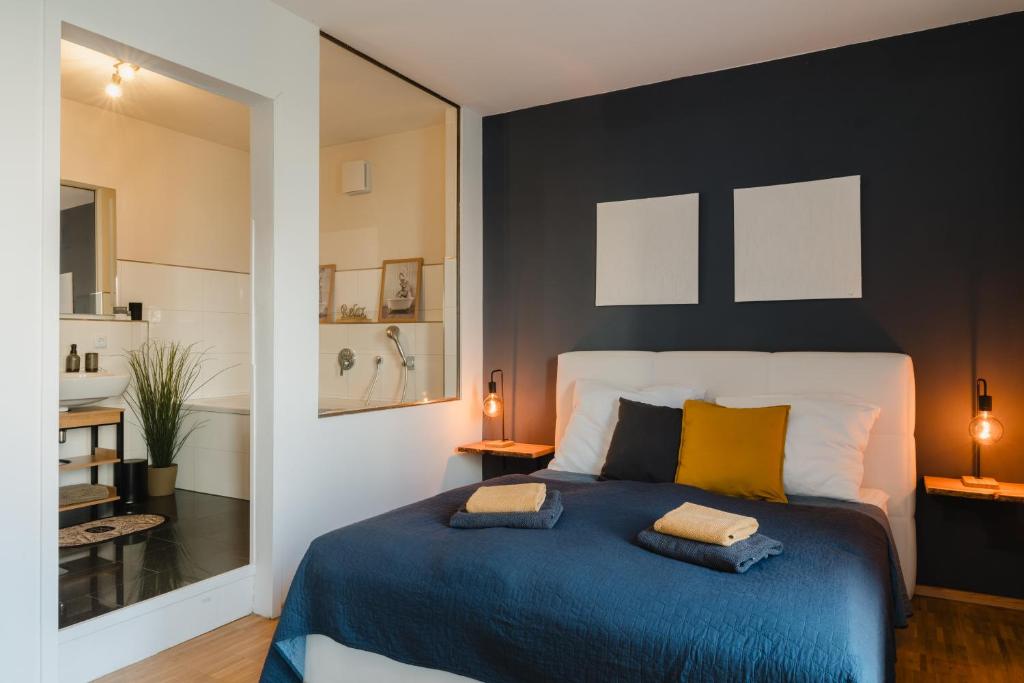 une chambre avec un lit bleu avec deux oreillers dessus dans l'établissement EXKLUSIVES Stadthaus auf zwei Etagen am Staatstheater, à Cottbus