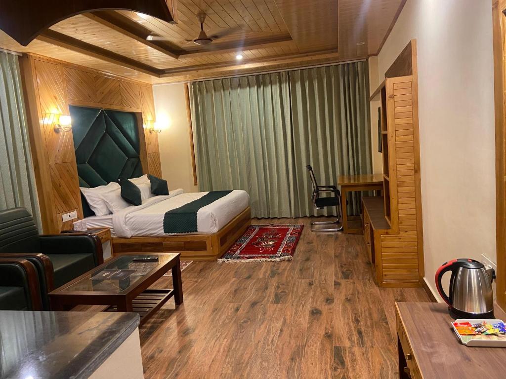 a hotel room with a bed and a living room at LN Grand Suite in Manāli