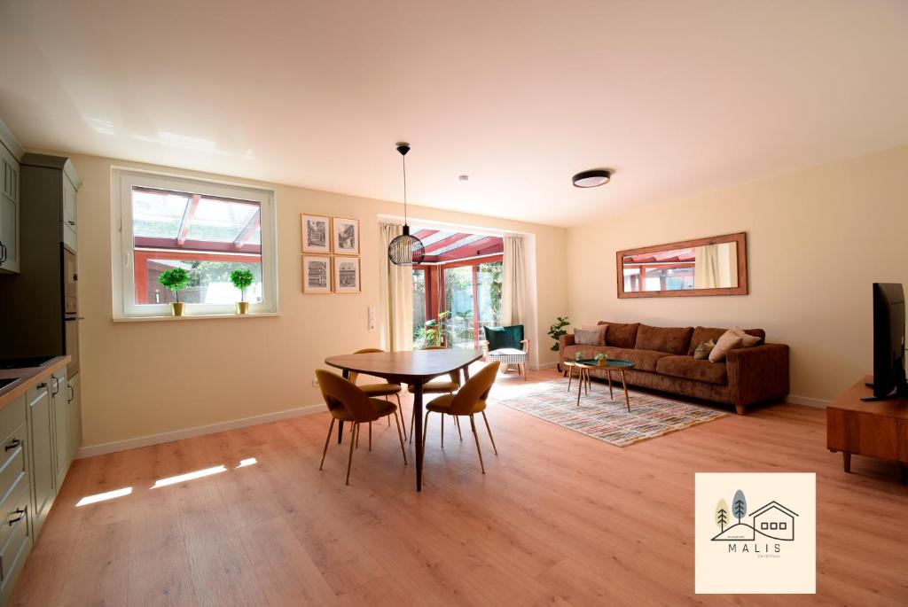 a living room with a table and a couch at Malis-Ferienhaus in Bad Harzburg