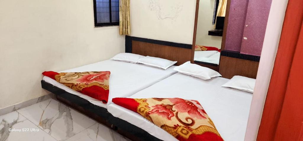 Postel nebo postele na pokoji v ubytování Hotel Sai Murlichandra Shirdi