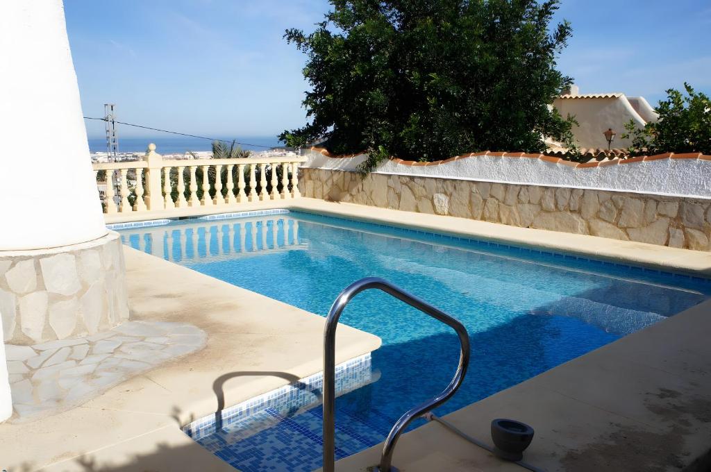 a swimming pool with a stair in the middle of a house at Elisabet in Denia