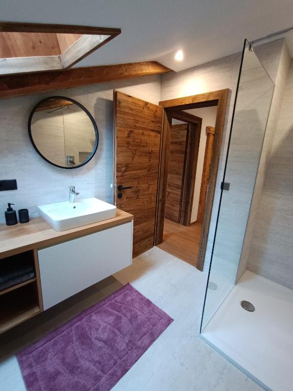 a bathroom with a sink and a mirror at kuglerhof in Dobbiaco