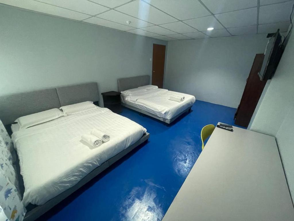 Postel nebo postele na pokoji v ubytování M Straits Hotel