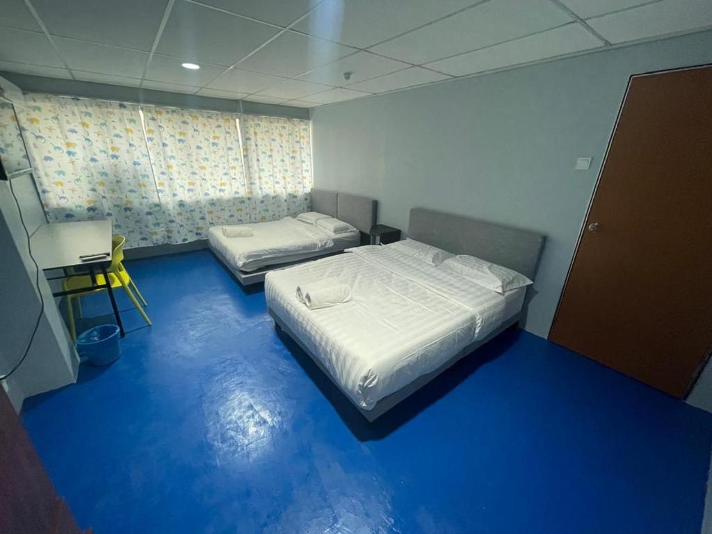 Postel nebo postele na pokoji v ubytování M Straits Hotel