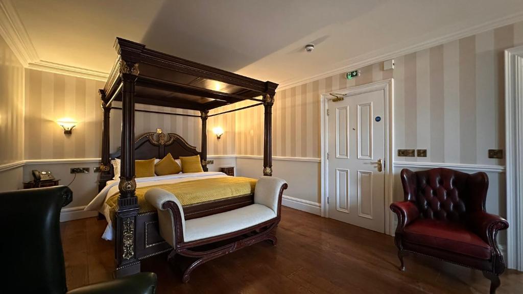 A bed or beds in a room at Sweeney's Hotel 2020 Limited