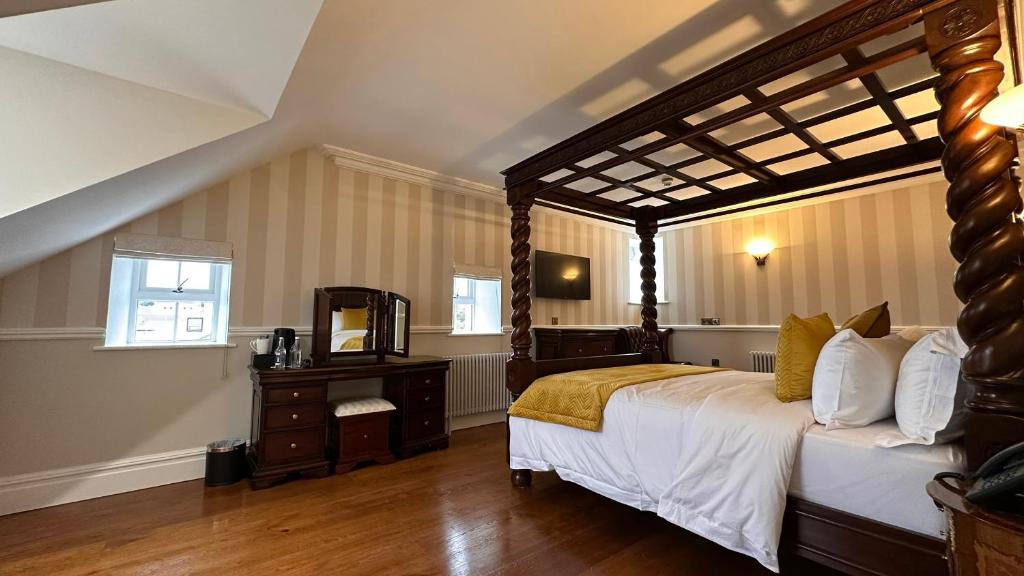 A bed or beds in a room at Sweeney's Hotel 2020 Limited