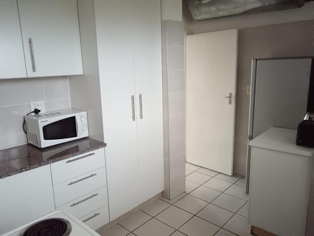 una piccola cucina con forno a microonde su un bancone di Stralenberg a Margate