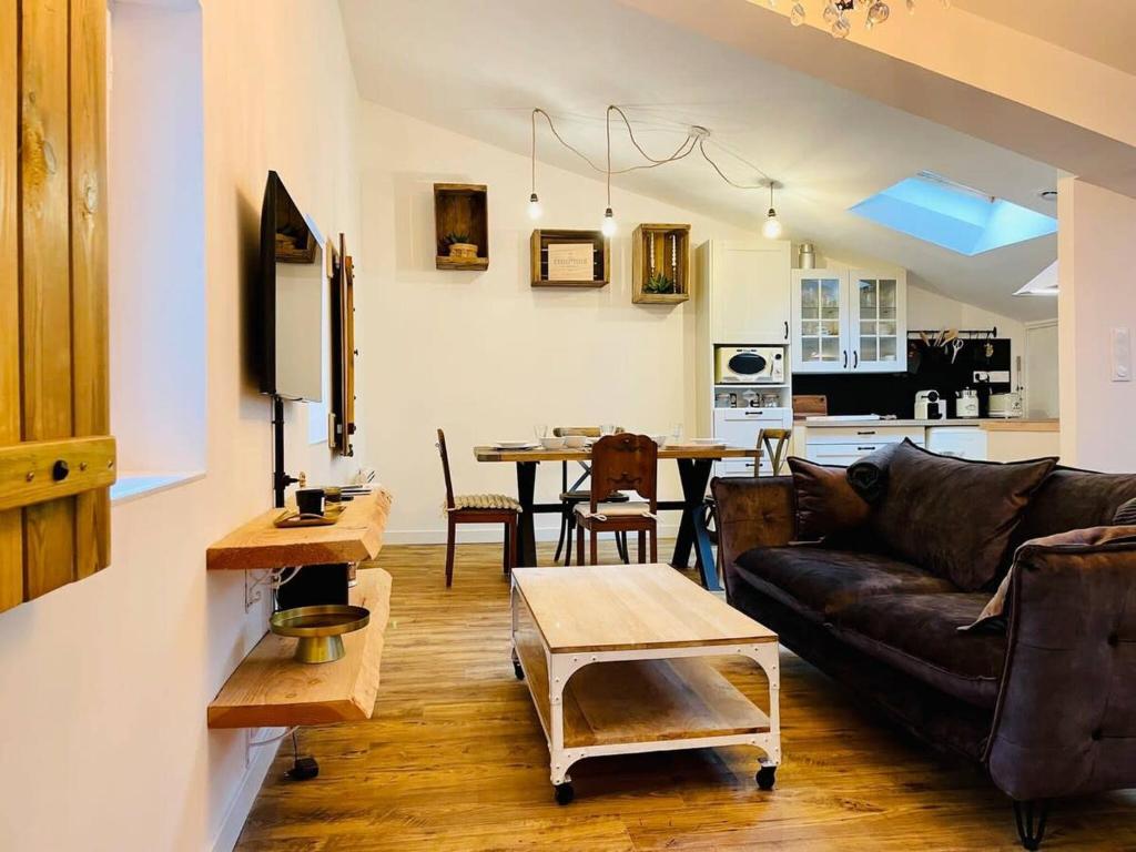 a living room with a couch and a table at Le Boudoir de Thais in La Rochelle