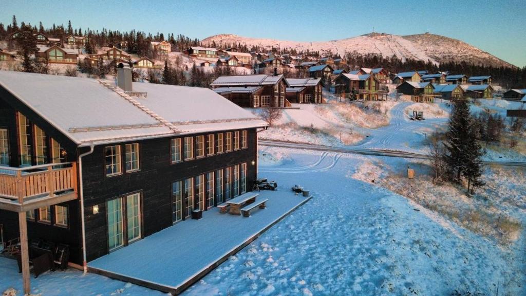 an aerial view of a building in the snow at Ski-in/Ski-out | Sauna | Pets OK | Free EV-charge in Lofsdalen