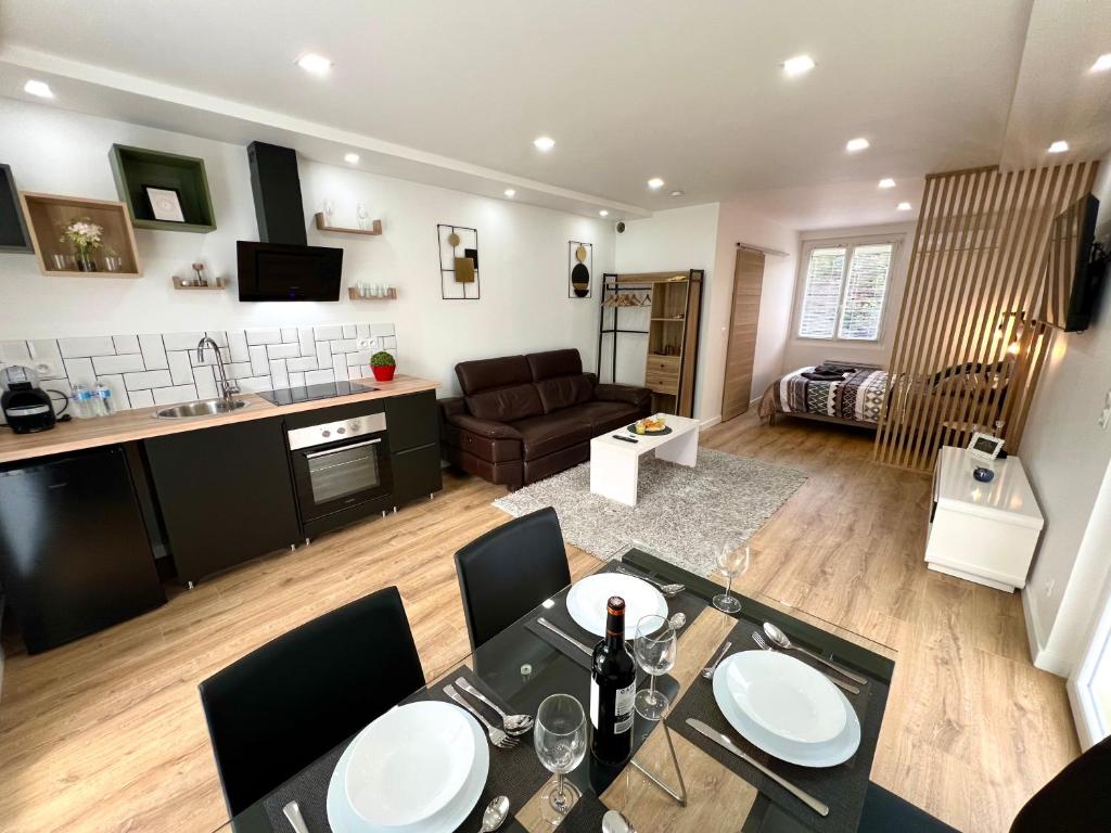une cuisine et un salon avec une table et des chaises dans l'établissement Luxurino Résidence 4, à Launaguet