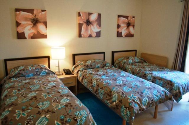 Postel nebo postele na pokoji v ubytování Hotel Kappara