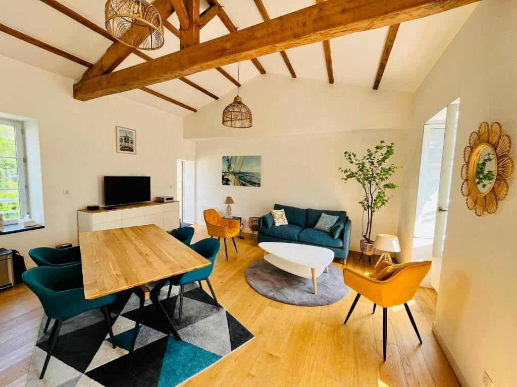 un salon avec un canapé bleu et une table dans l'établissement La Chaloupe - Terrasse et Wifi, à La Rochelle