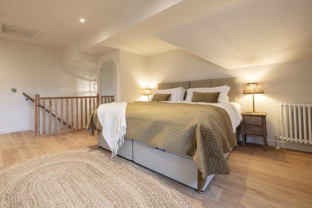 a bedroom with a large bed and a rug at The Dog Kennels in Leyburn