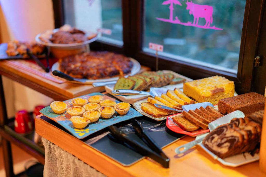 a buffet with different types of food on a table at Logis Hôtel et Spa Le Christiania in La Salle-les-Alpes