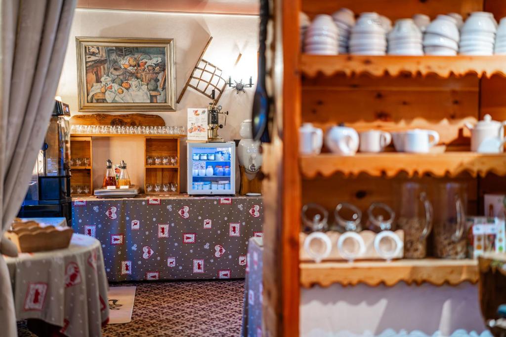 a shop with dishes and other items on shelves at Logis Hôtel et Spa Le Christiania in La Salle-les-Alpes