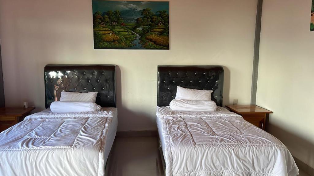 Postel nebo postele na pokoji v ubytování Matraville Home Stay Tuk Tuk Lake Toba Samosir