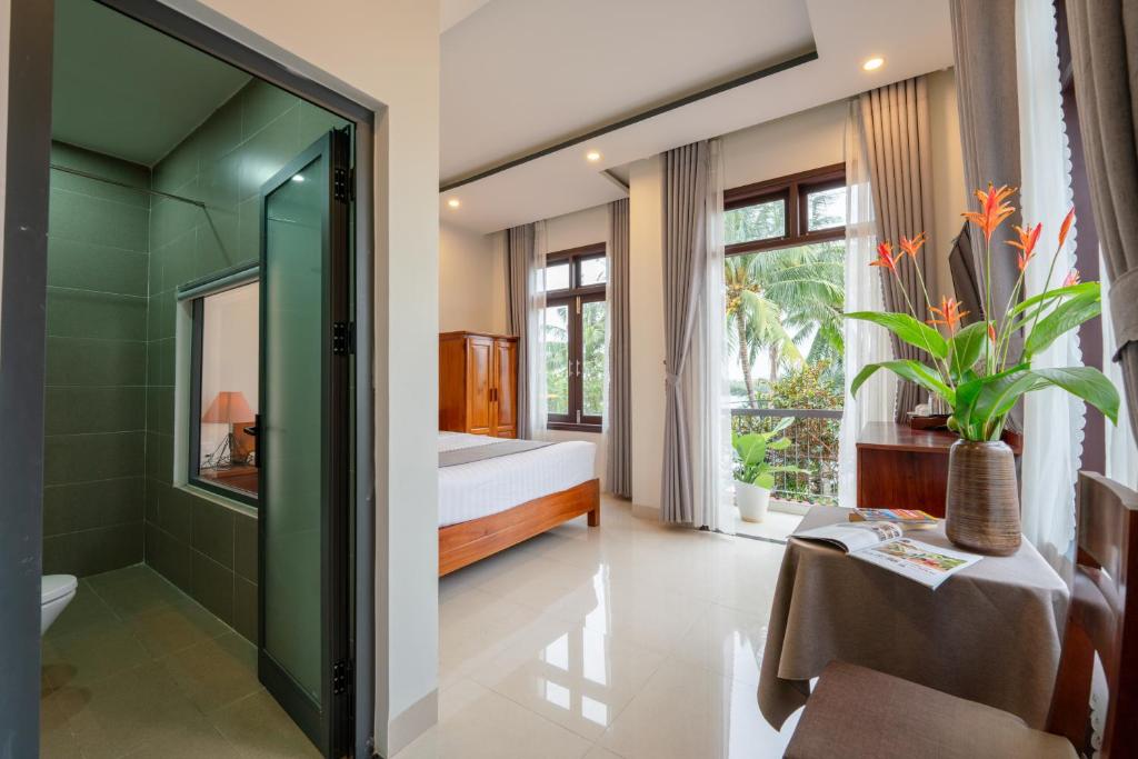 Postel nebo postele na pokoji v ubytování Phuoc Dat Riverside Homestay Hoi An