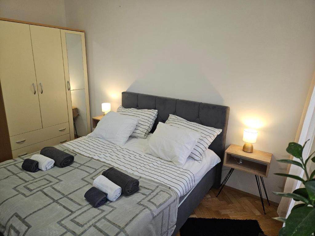 a bedroom with a bed with two towels on it at Apartman Judita in Zagreb