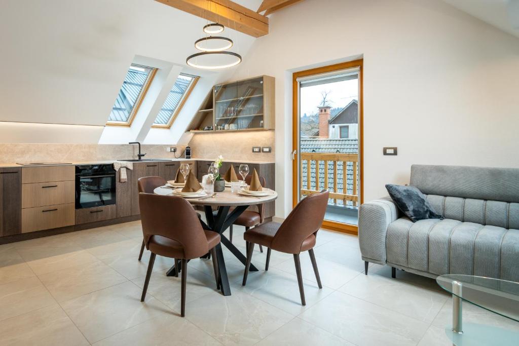 a living room with a table and chairs and a couch at Apartma pri Hrvatu in Bohinj