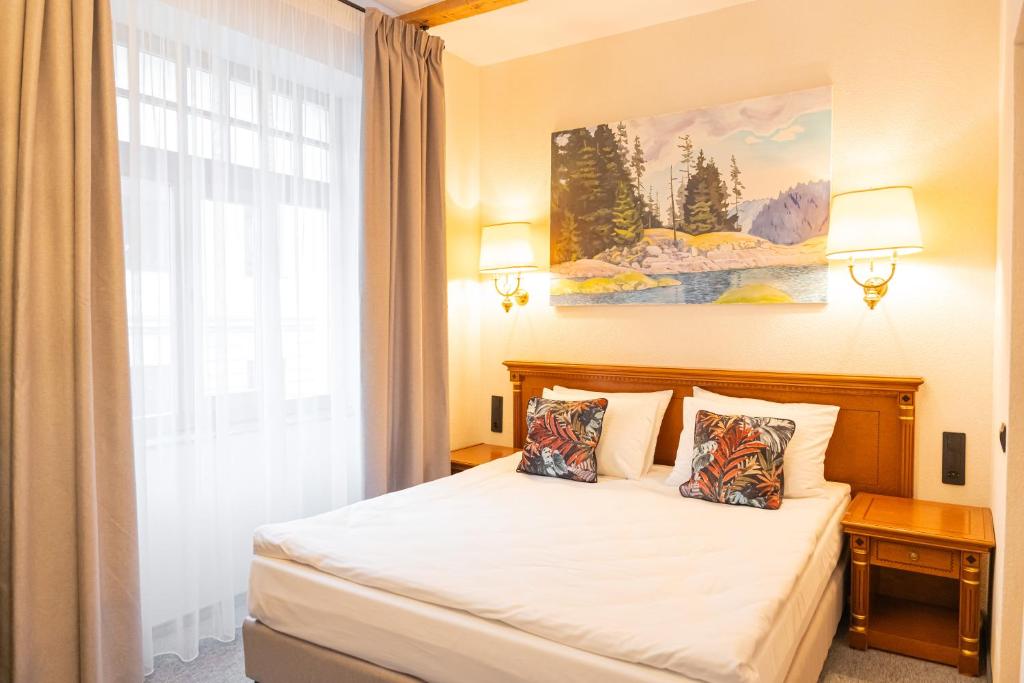 a bedroom with a bed and a large window at Epic rooms in Braşov