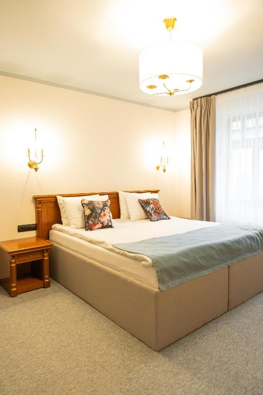 a bedroom with a large bed and a window at Epic rooms in Braşov
