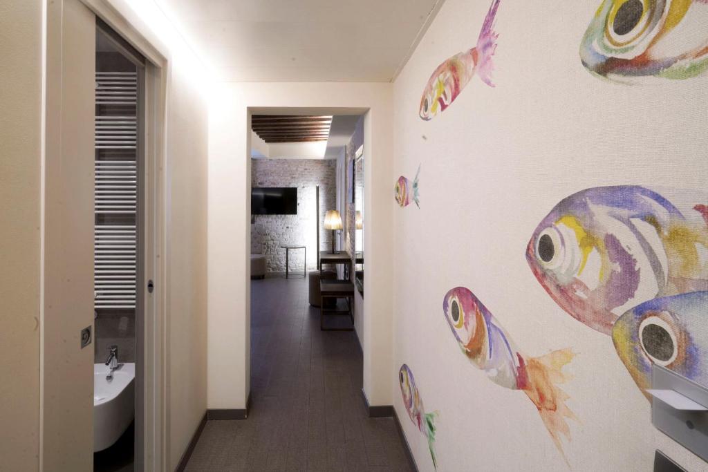 a bathroom with a wall with fish stickers on it at Hotel Aquarius Venice - Ascend Collection in Venice