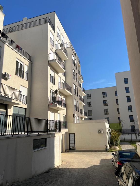an empty parking lot in front of a building at Kleon Apartament in Pristina