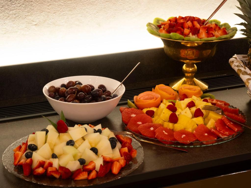a table topped with three plates of fruit and vegetables at Hotel Aquarius Venice - Ascend Collection in Venice