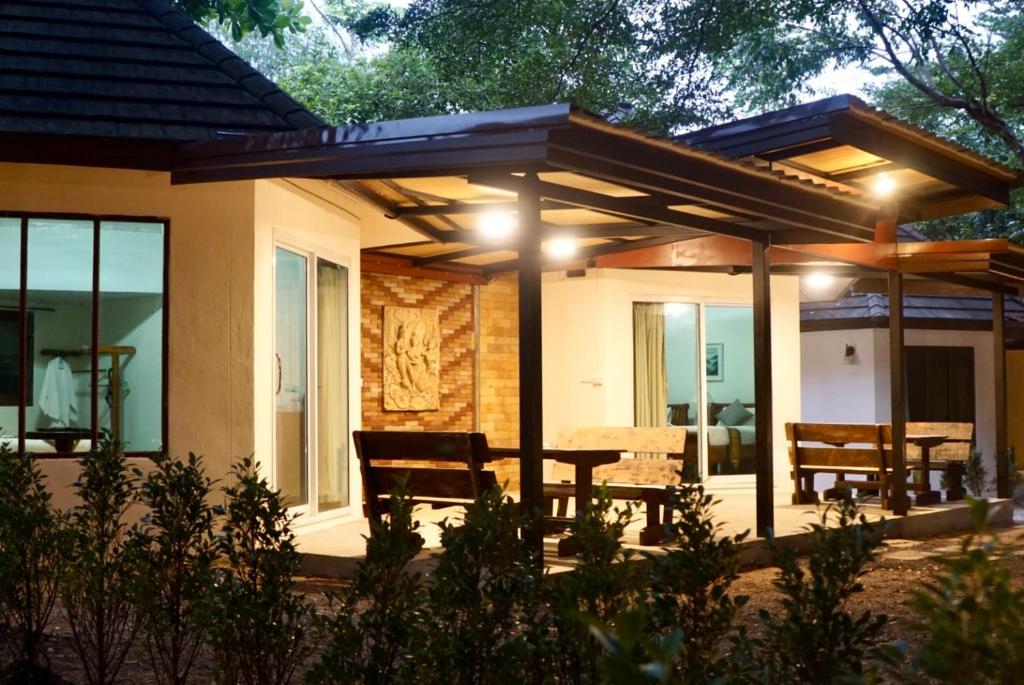 a house with a patio with a table and chairs at Avare House Krabi in Ao Nam Mao