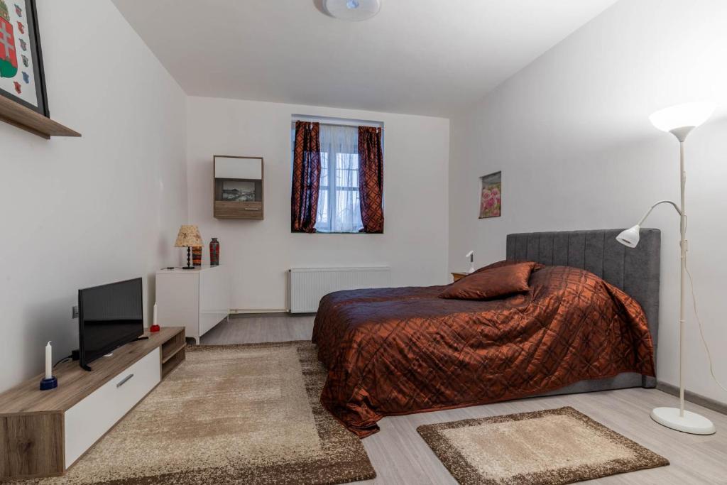 a bedroom with a bed and a flat screen tv at Varkert Green 16 in Budapest