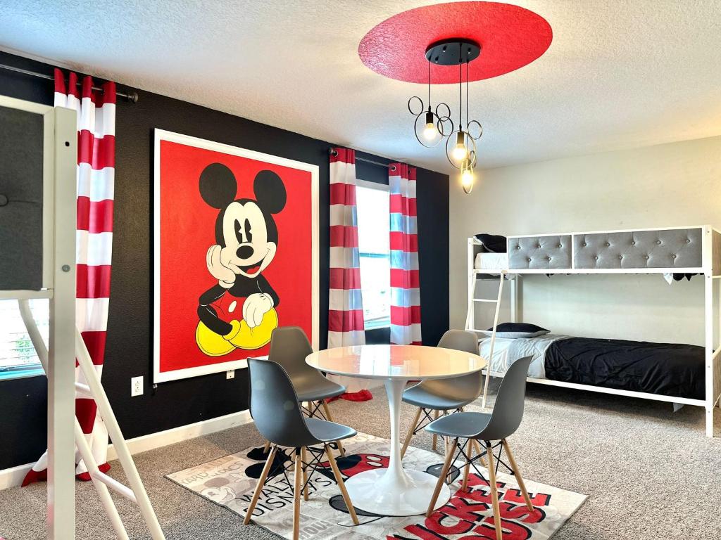 a room with a table and chairs and a bedroom at Amazing 9 bd 5 bath with pool spa 287 in Davenport