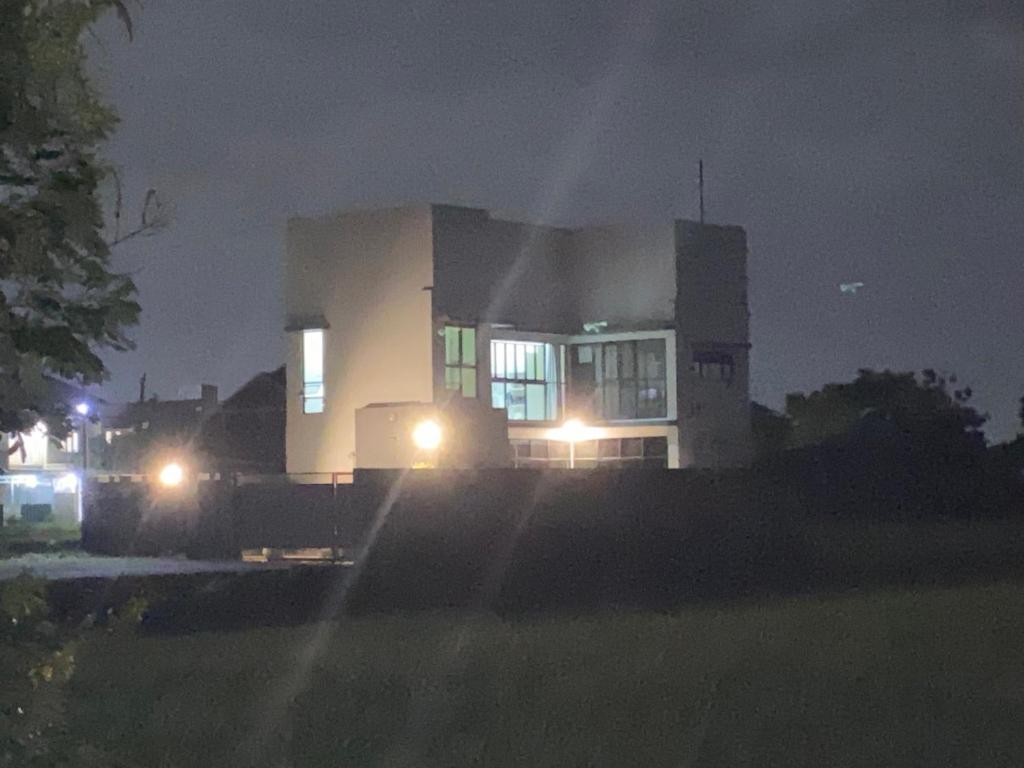 a house with lights in front of a building at night at Villa Mike Yogyakarta in Gandok
