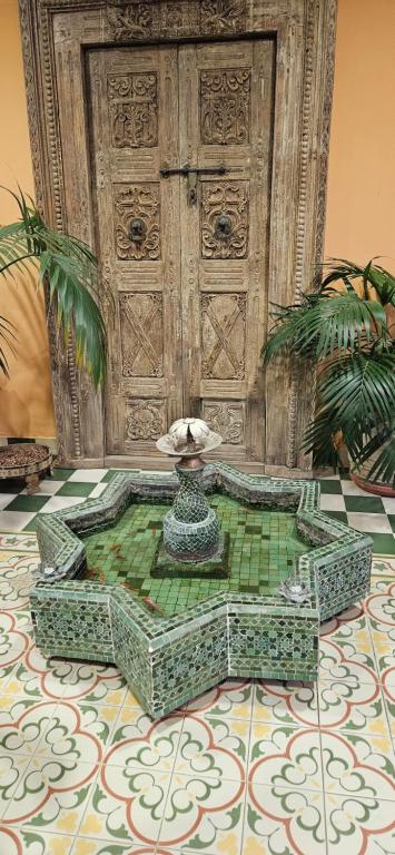 a fountain in the middle of a room with a tile floor at La Fonda Benissa, Grupo Terra de Mar in Benissa