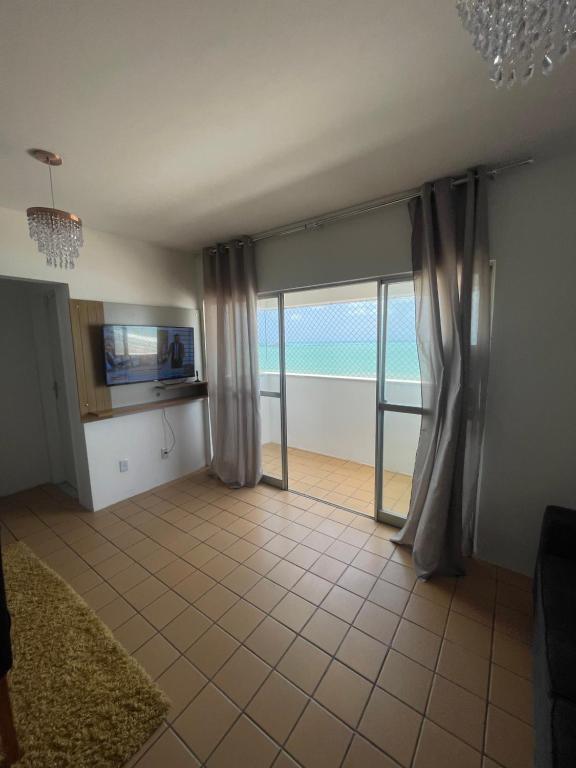 a living room with a view of the ocean at Apartamento Beira Mar in Maceió