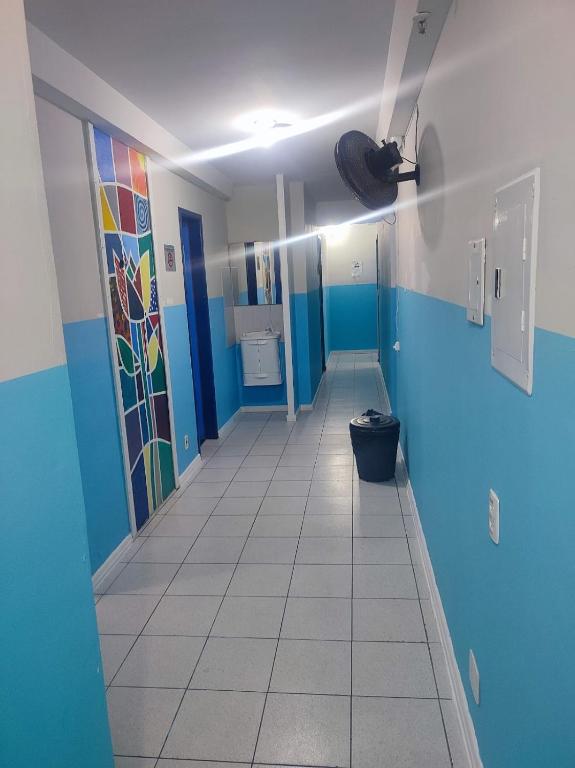a bathroom with blue and white walls and a toilet at Hostel Princess Copacabana in Rio de Janeiro