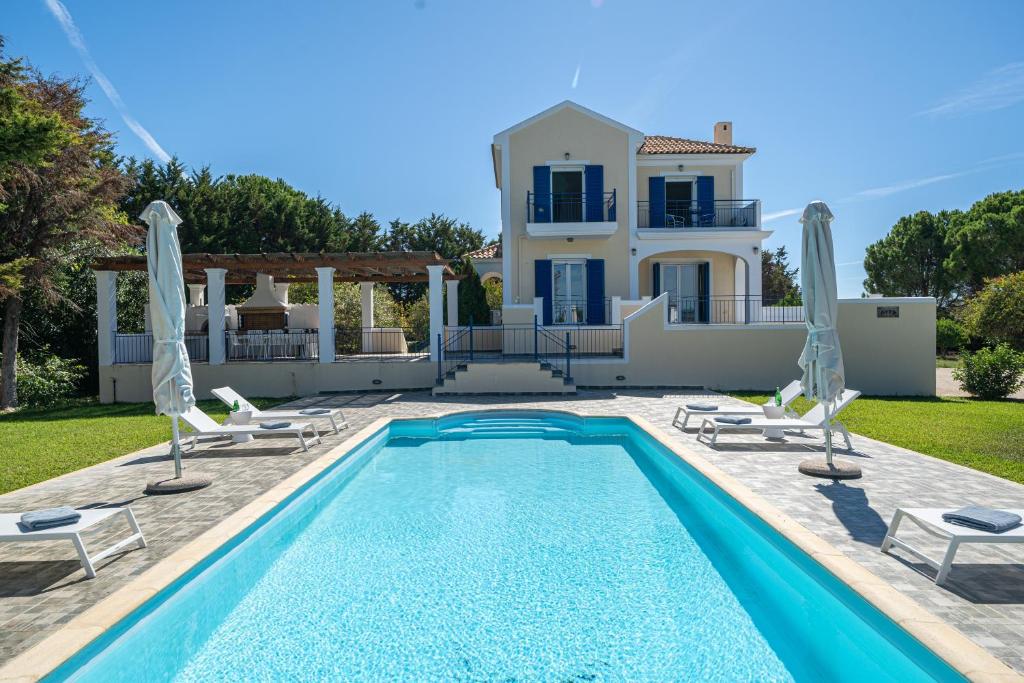 a villa with a swimming pool and a house at Eglina Celeste Villa in Minia
