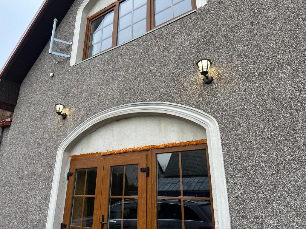a building with a door and two windows at D&R Apartments in Mažeikiai