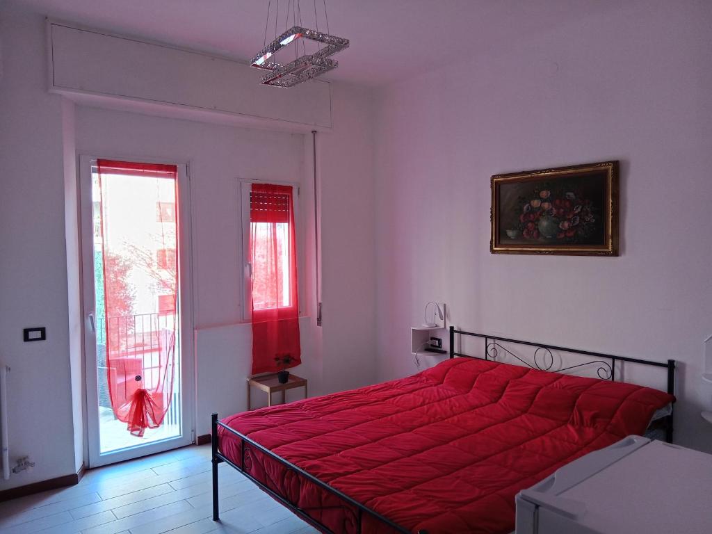 Un dormitorio con una cama con un edredón rojo. en Eros casa, en Milán