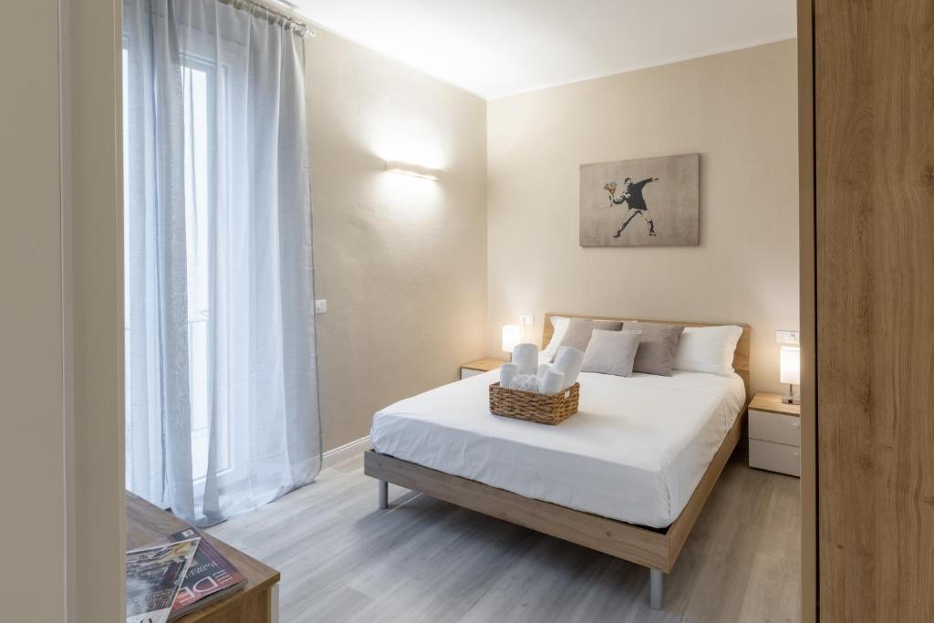 a bedroom with a bed and a large window at Bianca - Roby - Paolo Apartments by Mamo Florence in Florence