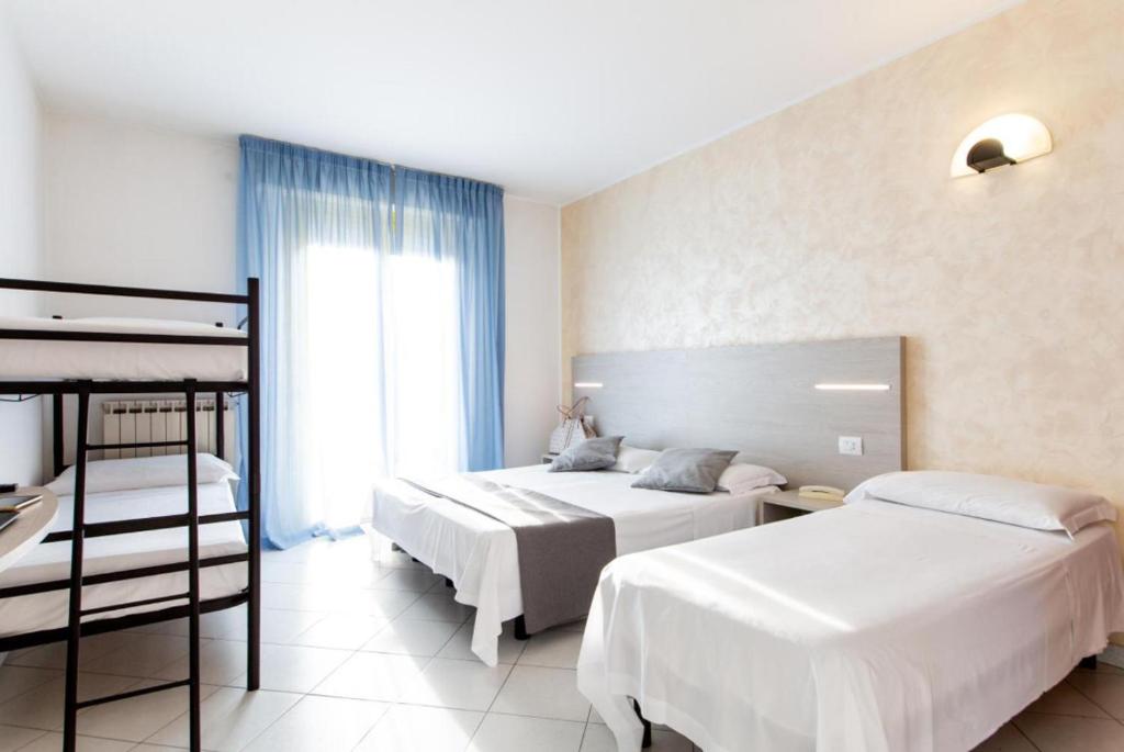 Postel nebo postele na pokoji v ubytování Hotel Napoleon