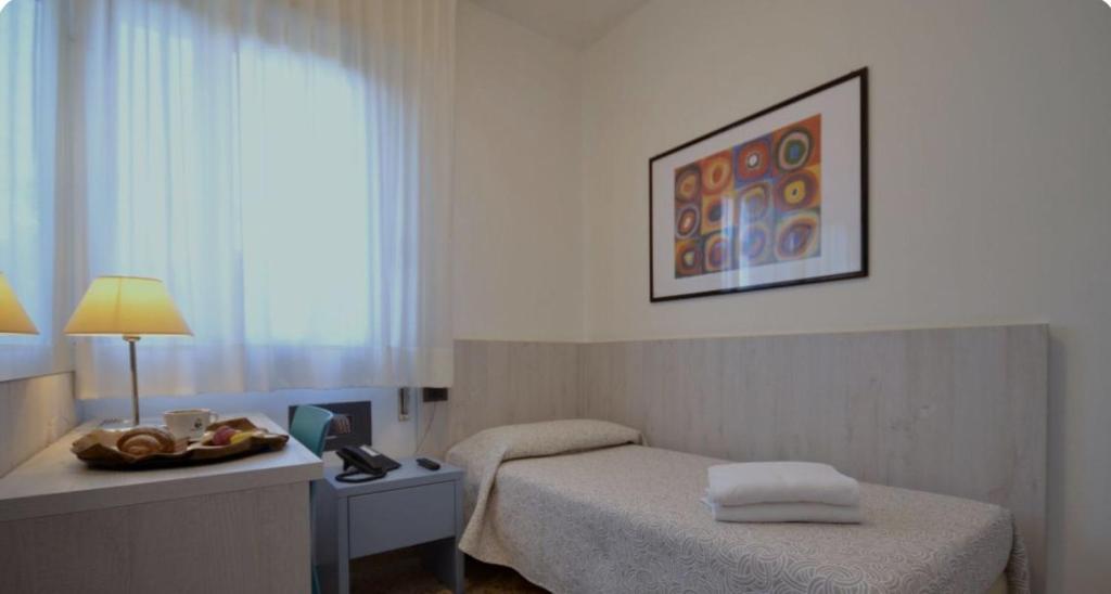 Postel nebo postele na pokoji v ubytování Hotel Napoleon