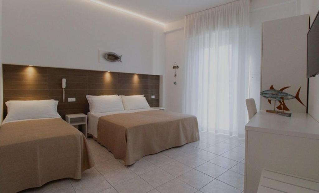 Postel nebo postele na pokoji v ubytování Hotel Napoleon