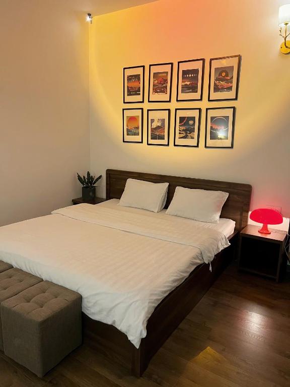 a bedroom with a large white bed with a red lamp at Villa Délight House “Stay&Chill” in Da Lat