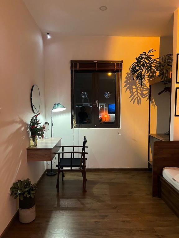 a room with a desk and a chair and a window at Villa Délight House “Stay&Chill” in Da Lat